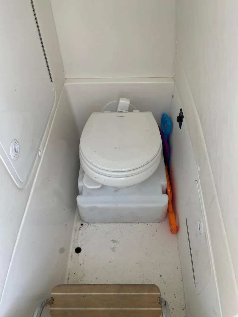 Slide: The Image of 2021 Regulator 26XO boat toilet compartment with cleaning tools. - 34