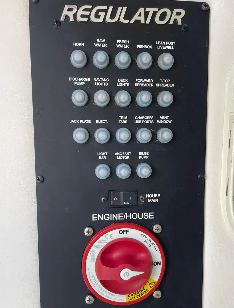 Slide: The Image of Control panel of a 2021 Regulator 26XO boat with various switches and a red dial. - 39