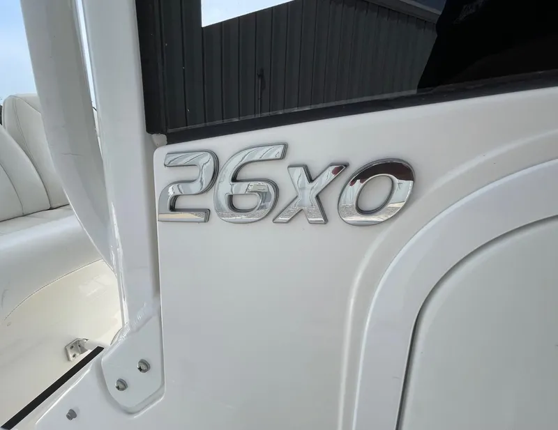 Slide: The Image of 2021 Regulator 26XO boat model emblem on white surface. - 42