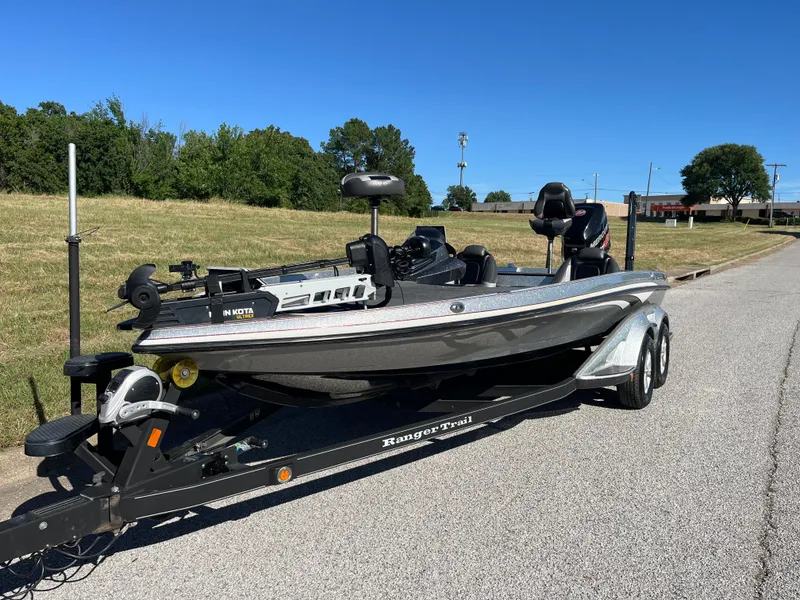 Slide: The Image of 2016 Ranger Z520 boat on trailer, parked on a road with grassy background. - 34