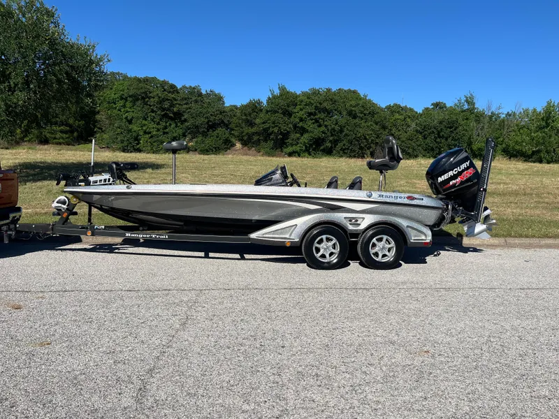 Slide: The Image of 2016 Ranger Z520 boat on trailer, parked on road with grassy background. - 37