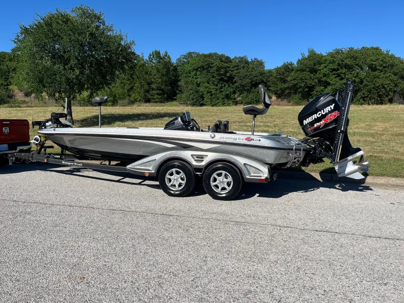 Slide: The Image of 2016 Ranger Z520 boat with Mercury engine on trailer, parked on a sunny road. - 38