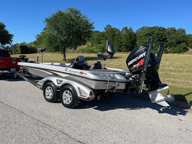 Slide: The Image of 2016 Ranger Z520 boat with Mercury engine on a trailer, parked on a sunny road. - 39