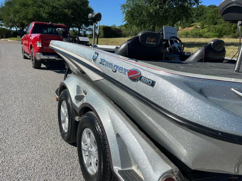 Slide: The Image of 2016 Ranger Z520 boat hitched to a red truck on a sunny day. - 41
