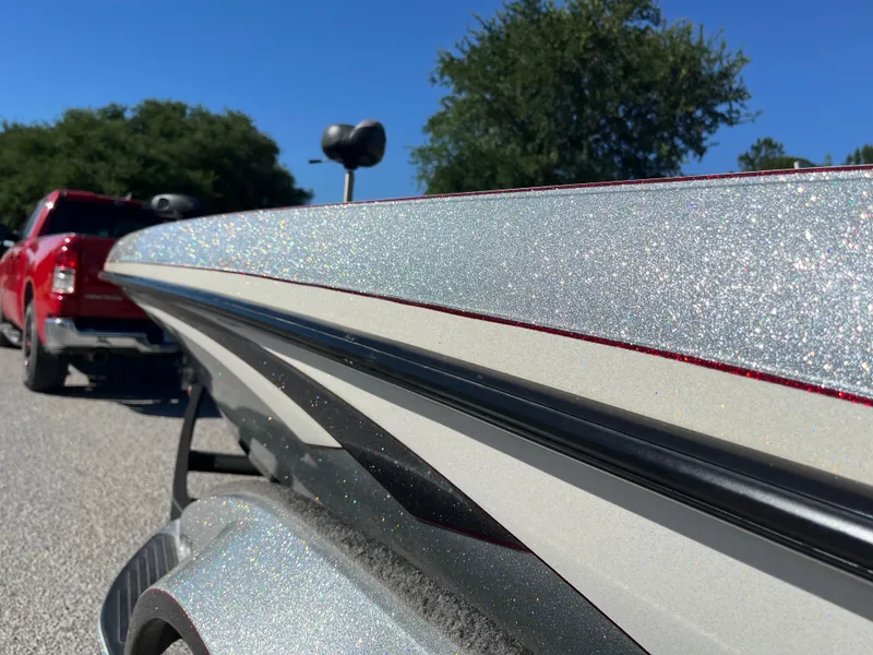 Slide: The Image of 2016 Ranger Z520 boat with glitter finish, parked on a sunny day, red truck in background. - 42