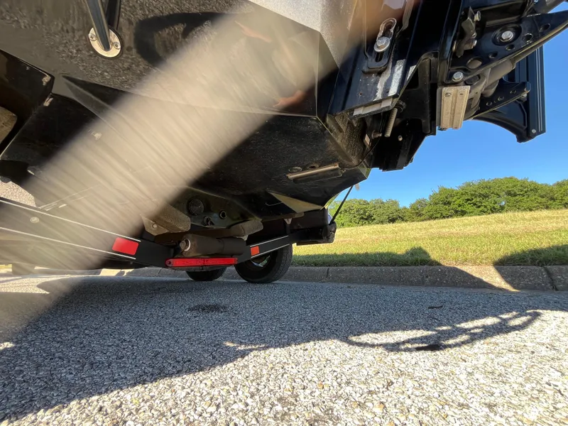 Slide: The Image of Underneath view of a 2016 Ranger Z520 boat on a trailer, parked on asphalt. - 45
