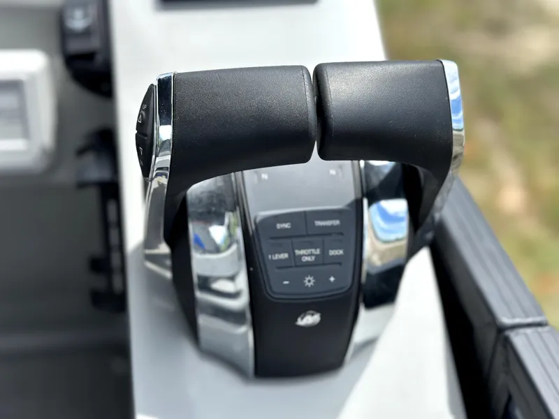 Slide: The Image of Throttle controls of 2022 Manitou 25 LX SHP DE boat, featuring sleek design and functionality. - 14