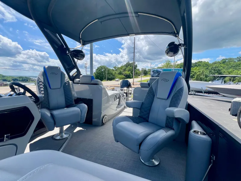 Slide: The Image of 2022 Manitou 25 LX SHP DE boat interior with plush seating and modern design. - 20