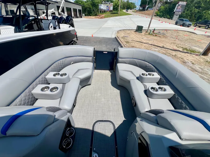 Slide: The Image of 2022 Manitou 25 LX SHP DE pontoon boat with spacious seating and cup holders. - 21