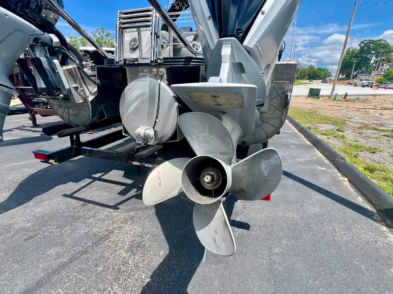 Slide: The Image of 2022 Manitou 25 LX SHP DE boat propeller and engine detail on a sunny day. - 23