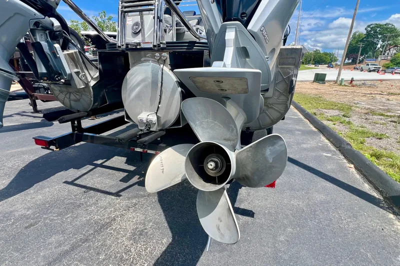 Slide: The Image of Rear view of 2022 Manitou 25 LX SHP DE boat propeller on pavement. - 28