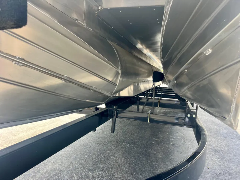 Slide: The Image of Underneath view of 2022 Manitou 25 LX SHP DE pontoon boat on trailer. - 32