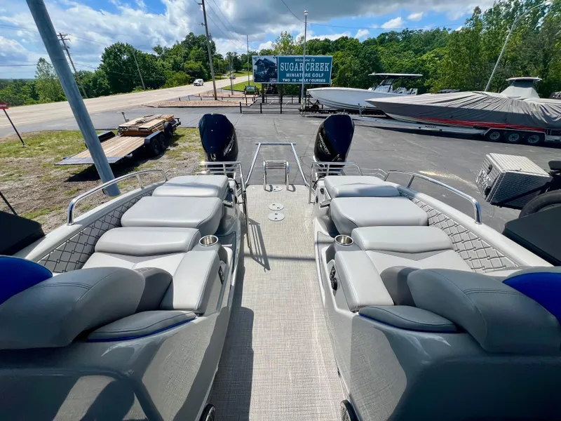 Slide: The Image of 2022 Manitou 25 LX SHP DE pontoon boat with luxurious seating and scenic outdoor view. - 5