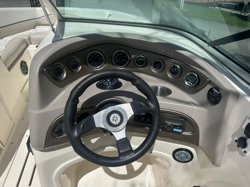 Slide: The Image of Dashboard of a 2007 Bryant 240BR boat with steering wheel and gauges. - 5