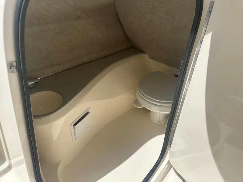 Slide: The Image of 2007 Bryant 240BR boat interior bathroom with toilet and sink. - 7
