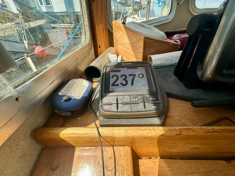 Slide: The Image of Navigation equipment inside a 1985 Fisher 34 Pilothouse Ketch, displaying a heading of 237 degrees. - 15