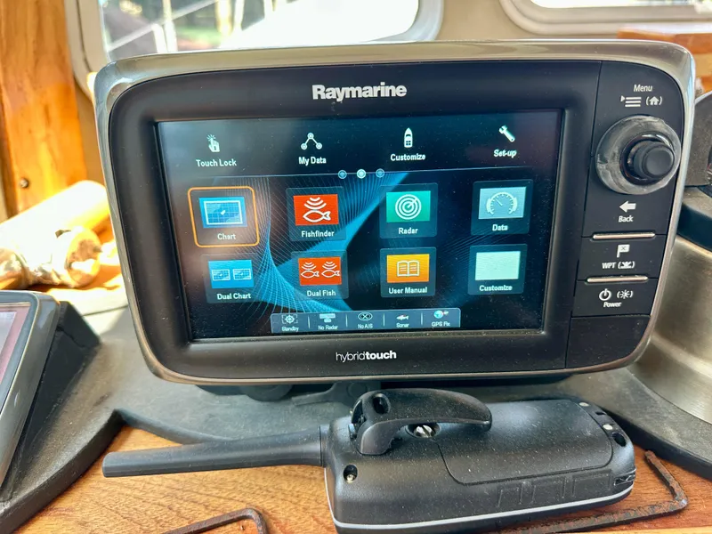 Slide: The Image of Raymarine navigation system on 1985 Fisher 34 Pilothouse Ketch, displaying chart and radar options. - 17