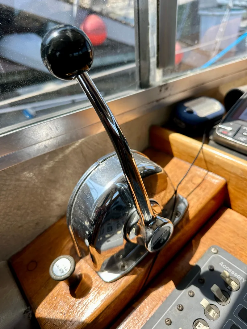 Slide: The Image of Chrome throttle lever on 1985 Fisher 34 Pilothouse Ketch, wooden console background. - 25