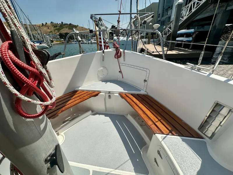 Slide: The Image of 1985 Fisher 34 Pilothouse Ketch cockpit with wooden benches and nautical ropes. - 29