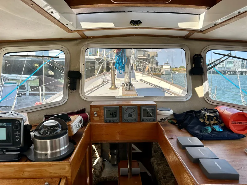 Slide: The Image of Interior view of 1985 Fisher 34 Pilothouse Ketch, showcasing navigation instruments and deck. - 30