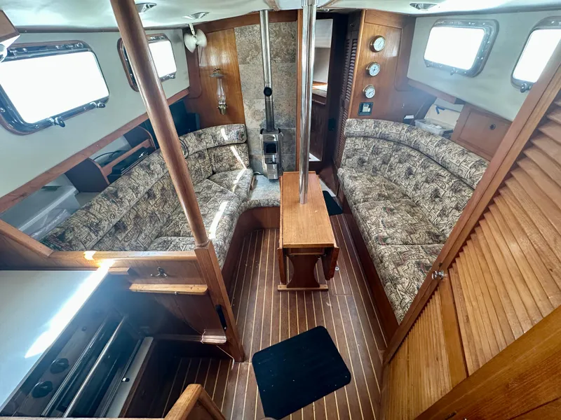 Slide: The Image of Interior of 1985 Fisher 34 Pilothouse Ketch with wood finish and cozy seating area. - 31