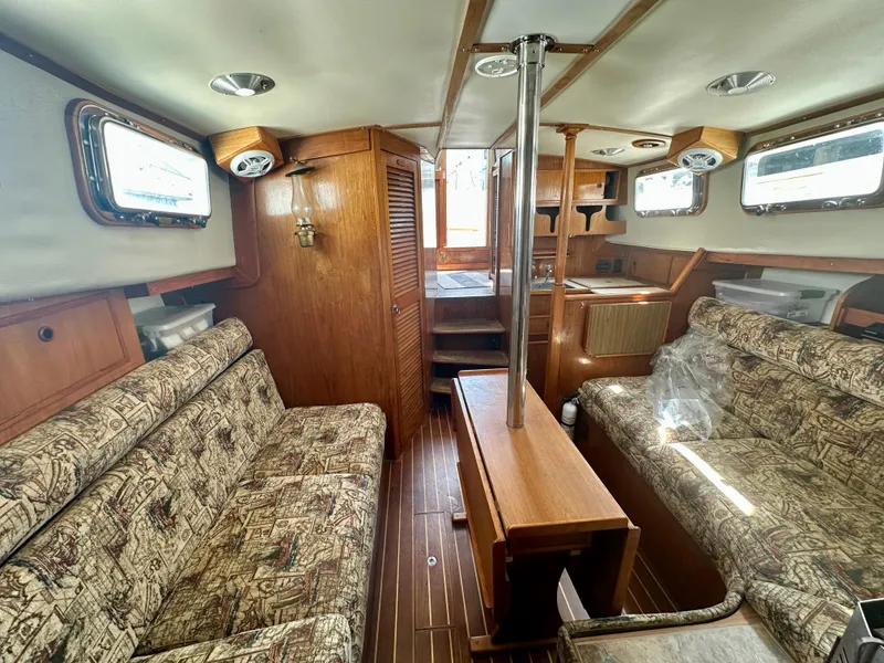 Slide: The Image of Interior of 1985 Fisher 34 Pilothouse Ketch with wood finish and patterned seating. - 32