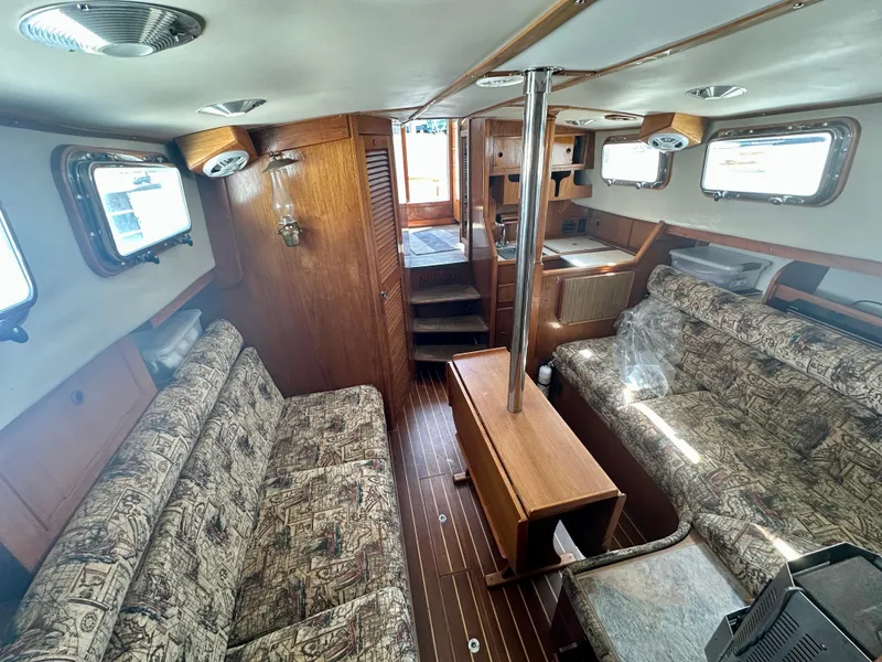 Slide: The Image of Interior of 1985 Fisher 34 Pilothouse Ketch with wood finish and patterned seating. - 33