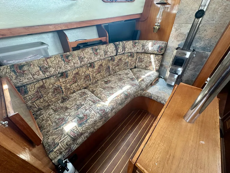 Slide: The Image of Interior of 1985 Fisher 34 Pilothouse Ketch with patterned seating and wood accents. - 35