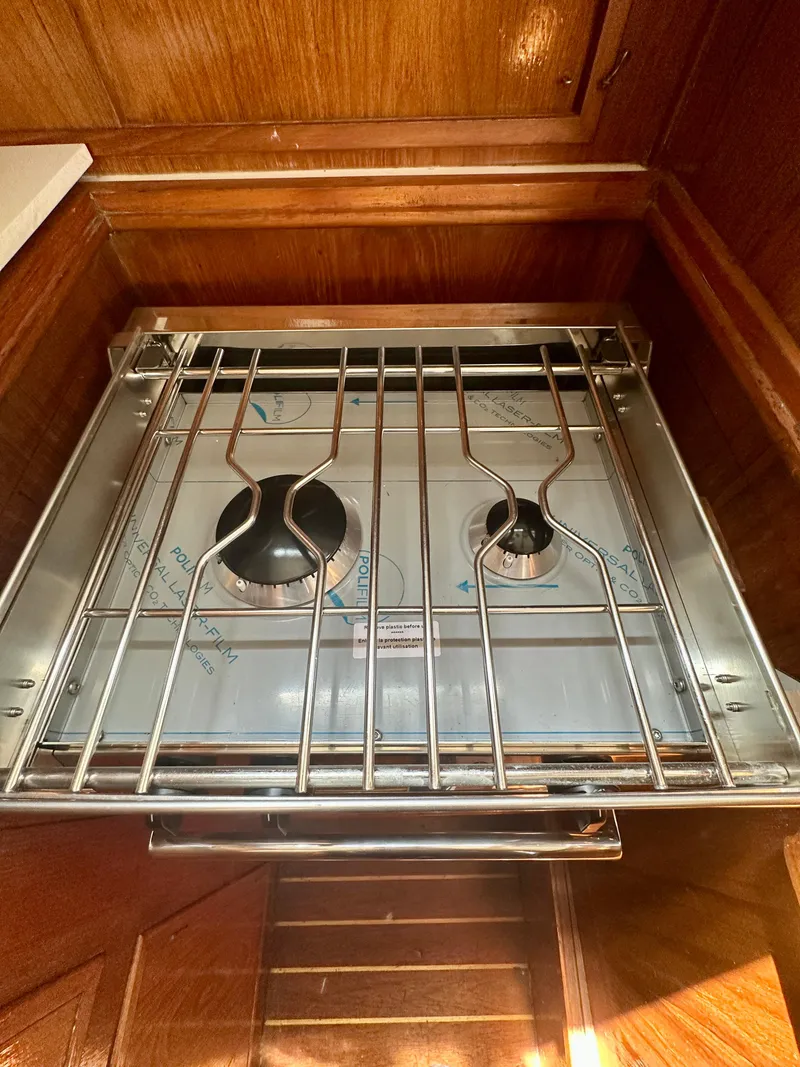 Slide: The Image of Stove in 1985 Fisher 34 Pilothouse Ketch with wooden cabinetry. - 43