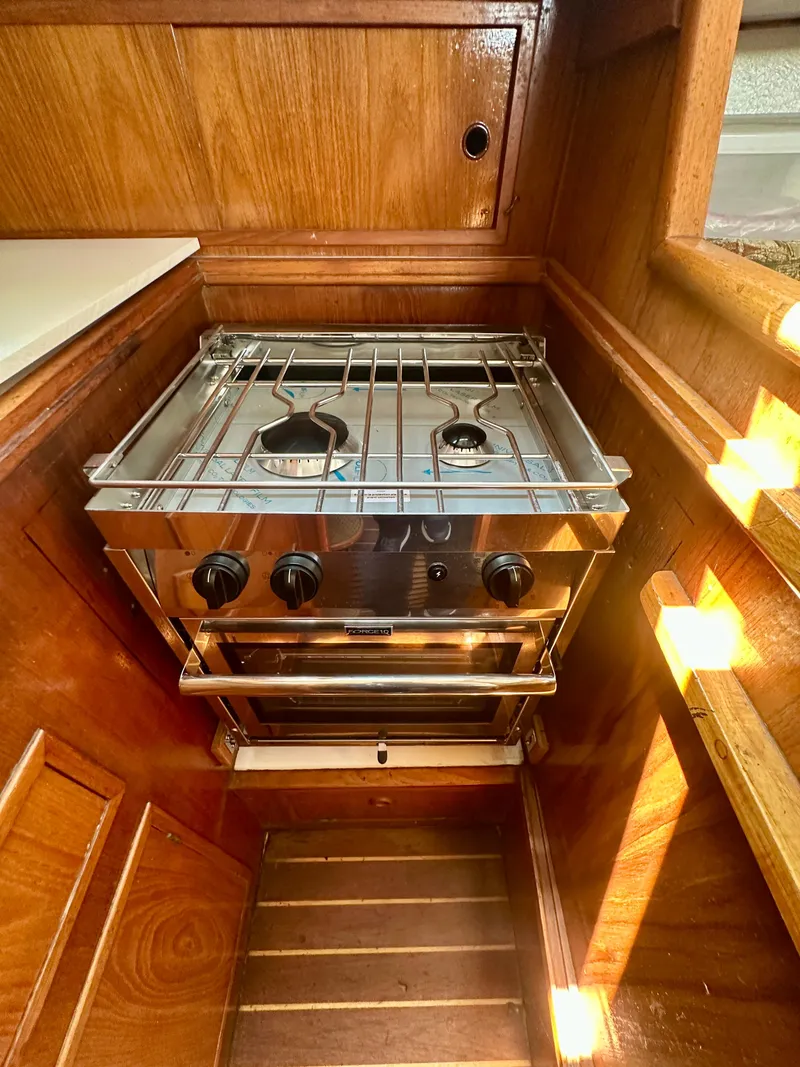 Slide: The Image of Stainless steel stove in 1985 Fisher 34 Pilothouse Ketch, wooden interior. - 44