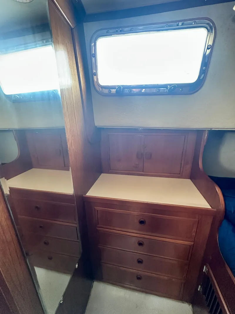 Slide: The Image of Interior of 1985 Fisher 34 Pilothouse Ketch with wooden cabinetry and porthole window. - 50