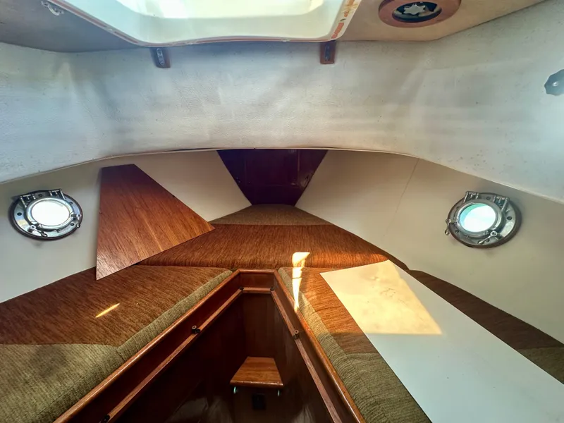 Slide: The Image of Interior of 1985 Fisher 34 Pilothouse Ketch with wooden accents and portholes. - 53
