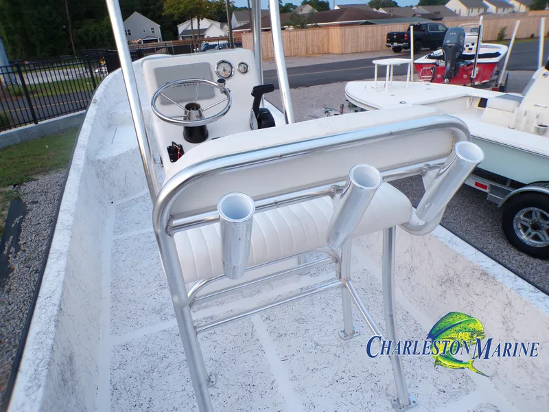 Slide: The Image of 2023 Panga 22 boat interior with steering console and rod holders, Charleston Marine logo visible. - 16