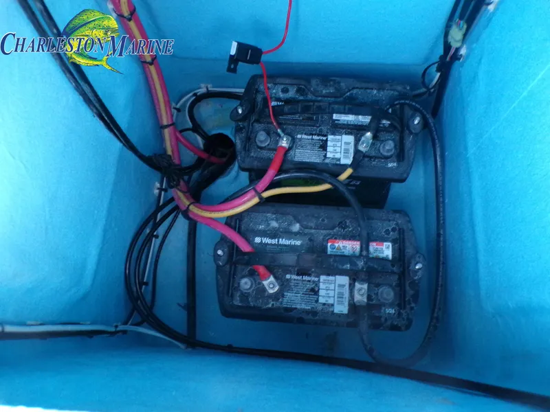 Slide: The Image of Two marine batteries with cables inside a Panga 22 boat, 2023 model. - 19