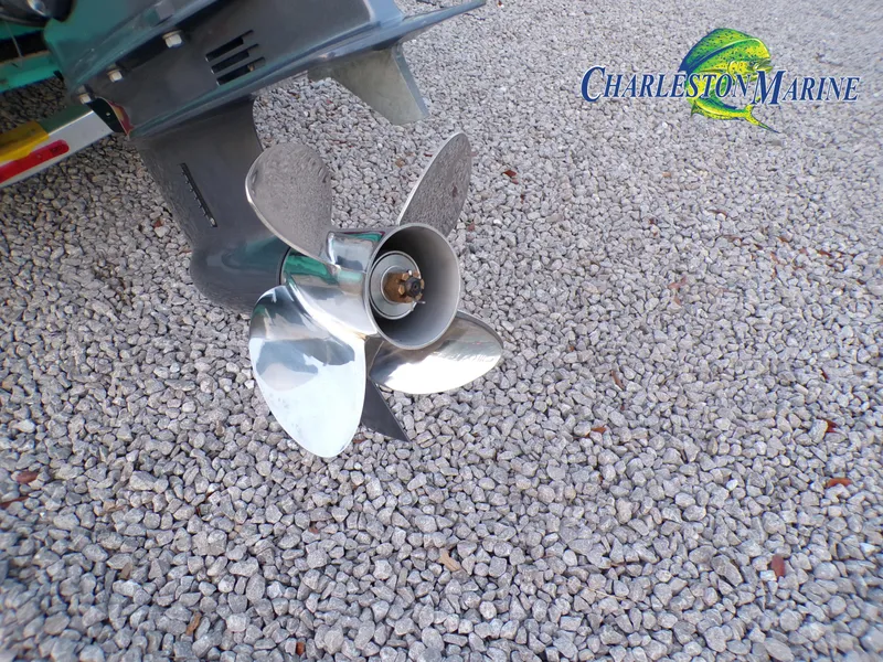 Slide: The Image of 2023 Panga 22 boat propeller on gravel, Charleston Marine logo visible. - 23