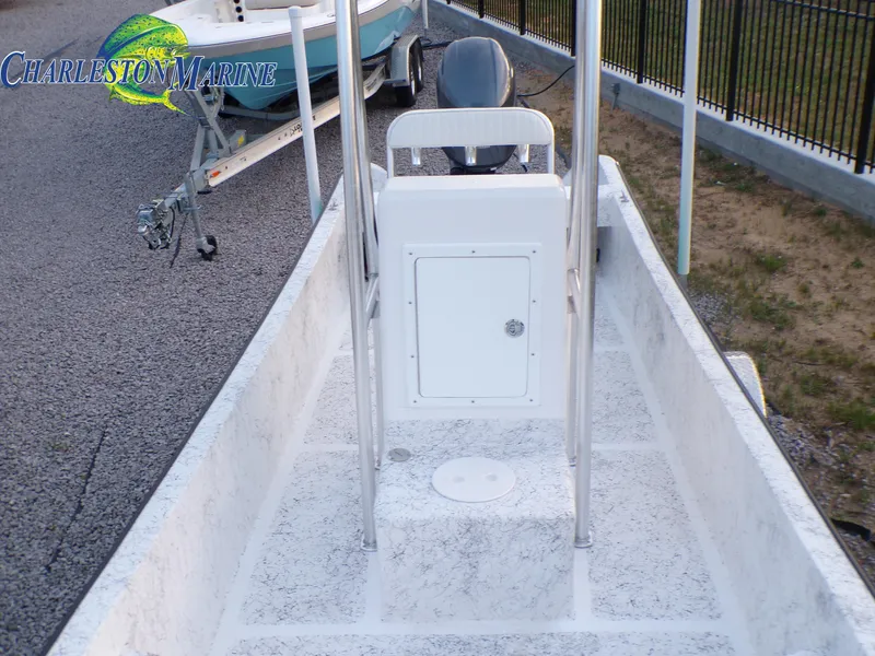 Slide: The Image of 2023 Panga 22 boat interior with console, parked on gravel near trailer. - 6