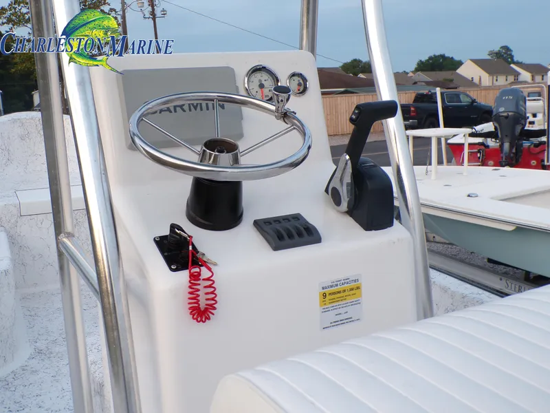 Slide: The Image of 2023 Panga 22 boat console with steering wheel, throttle, and gauges at Charleston Marine. - 9