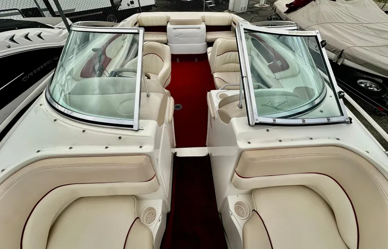 Slide: The Image of 1997 Sea Ray 210 Signature boat interior with beige seating and red carpet. - 10