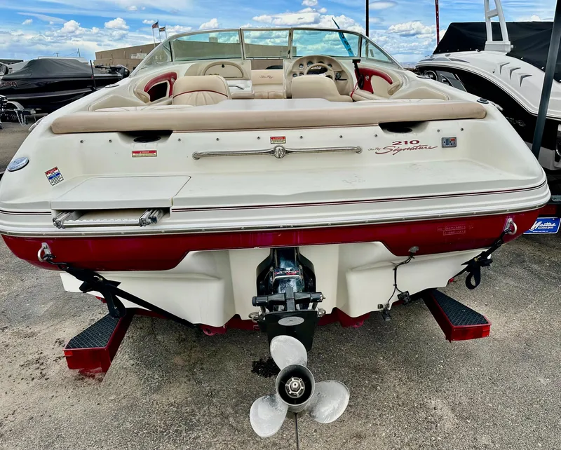 Slide: The Image of 1997 Sea Ray 210 Signature boat, rear view, showcasing propeller and seating. - 5