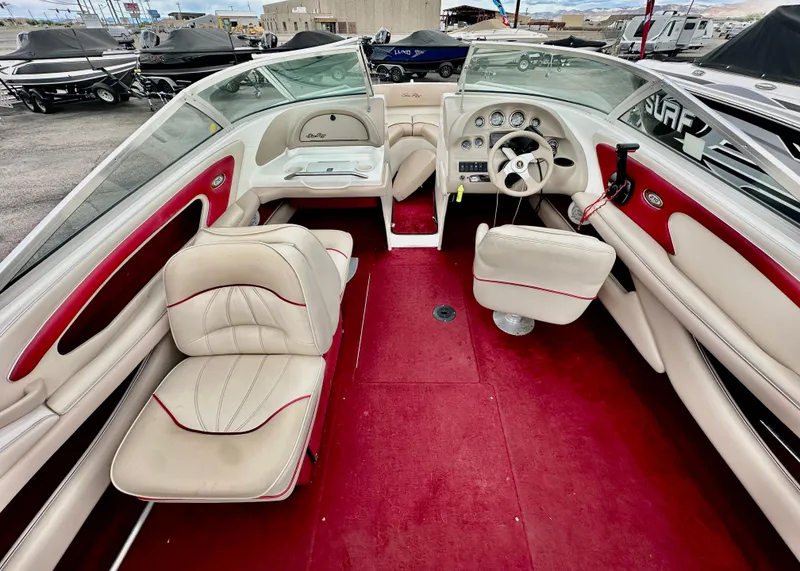 Slide: The Image of 1997 Sea Ray 210 Signature boat interior with red and white seating and dashboard. - 6