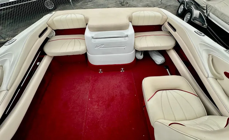 Slide: The Image of 1997 Sea Ray 210 Signature boat interior with red carpet and beige seating. - 7