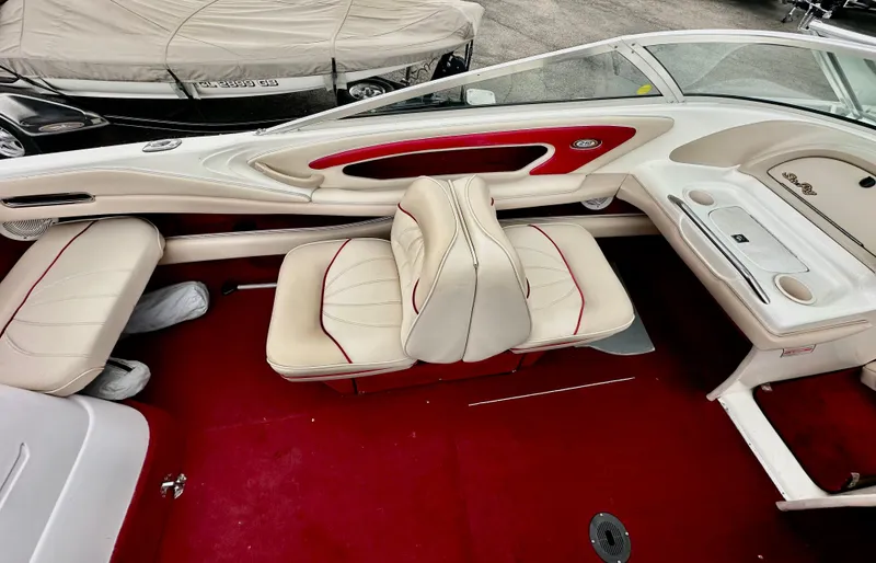 Slide: The Image of 1997 Sea Ray 210 Signature boat interior with red and white seating and dashboard. - 8