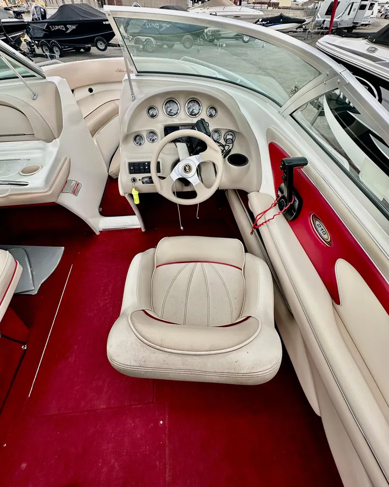 Slide: The Image of 1997 Sea Ray 210 Signature boat interior with red and white upholstery and dashboard controls. - 9
