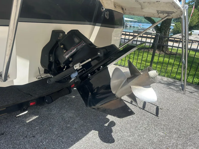 Slide: The Image of 2007 Bryant 240 boat with MerCruiser outdrive and propeller, parked on pavement. - 10