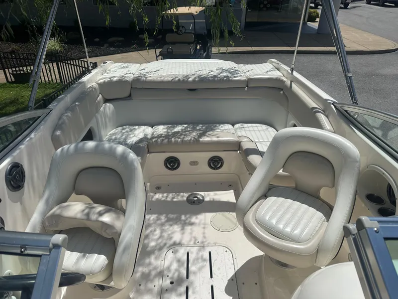 Slide: The Image of 2007 Bryant 240 boat interior with white seating and steering area. - 5