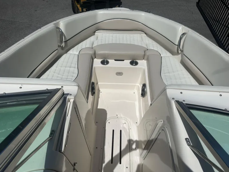 Slide: The Image of 2007 Bryant 240 boat interior with white seating and cup holders. - 8