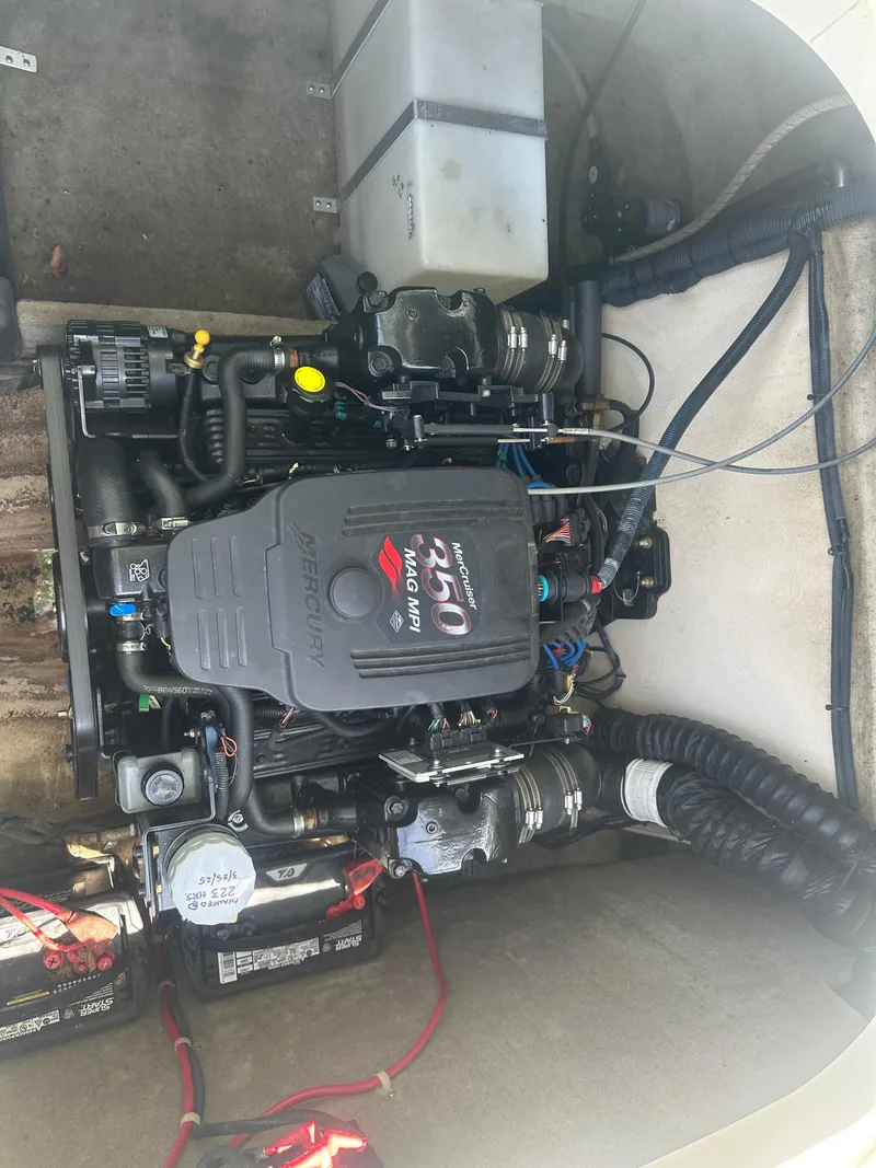 Slide: The Image of 2007 Bryant 240 boat engine compartment with visible components and wiring. - 9