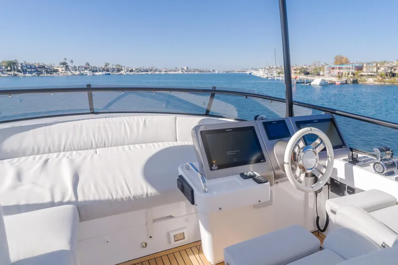 Slide: The Image of 2023 Azimut Magellano 66 yacht cockpit with modern navigation equipment and scenic water view. - 19