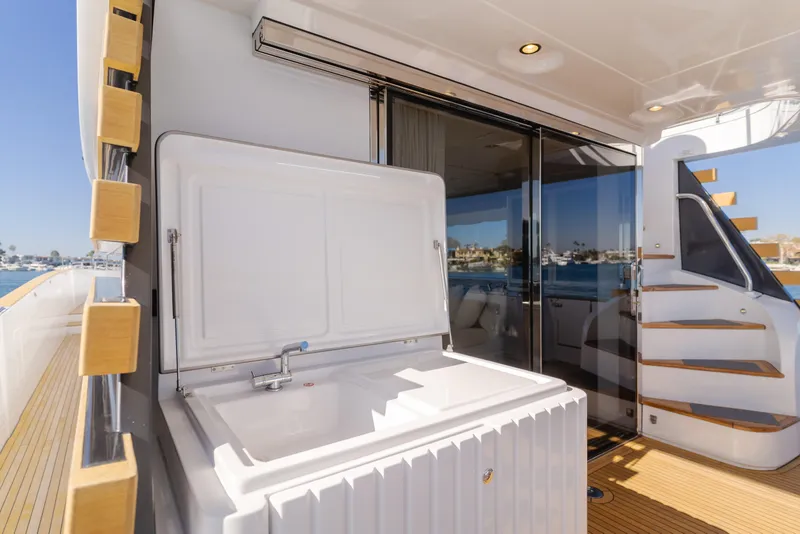 Slide: The Image of Luxury yacht Azimut Magellano 66, 2023 model, featuring outdoor sink and elegant deck design. - 27