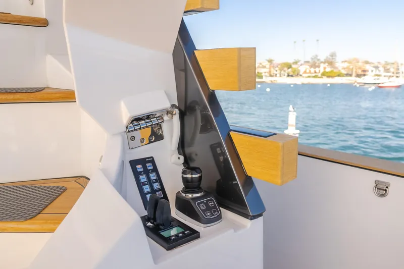 Slide: The Image of Control panel on 2023 Azimut Magellano 66 yacht, overlooking serene waterfront. - 28